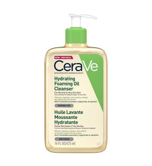 Bottle of Cerave Hydrating Foaming Oil Cleanser 473mls. Tranparent bottle with natural oil colour of product visible. Sitting on a white background.