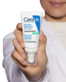 CeraVe oil control moisturizing gel-cream held in a hand with a blurred background