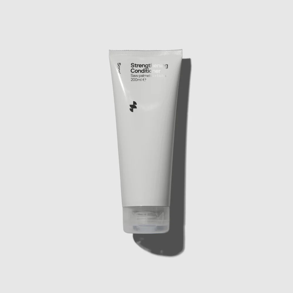 Image of light grey tube of Sons Conditioner against a light background with shadow behind it
