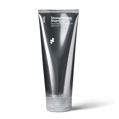 Deep silver grey tube of Sons Strengthening Shampoo on a white background.