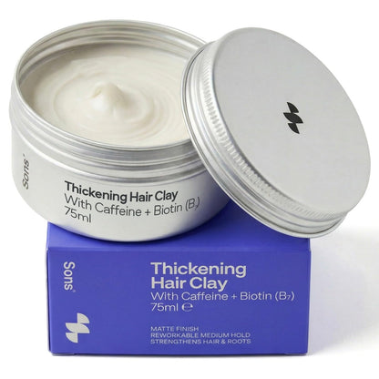 Open jar of thickening hair clay with purple packaging on a white background