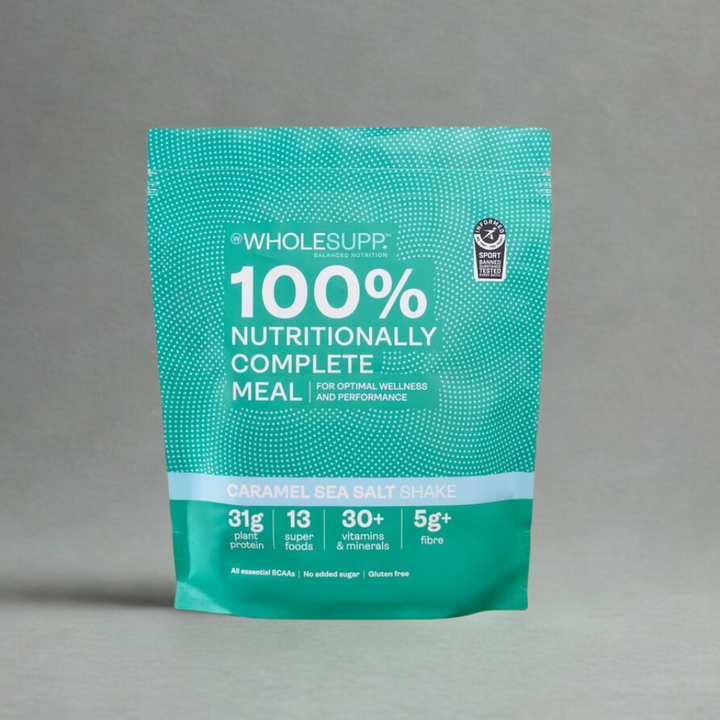 A stand-up pouch of Wholesupp 100% Nutritionally Complete Meal in Caramel Sea Salt Shake flavor, shown on a neutral gray background.