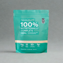 A stand-up pouch of Wholesupp 100% Nutritionally Complete Meal in Vanilla Shake flavour, featuring a teal and green design with white text on a neutral gray background. Contains 31g plant protein.