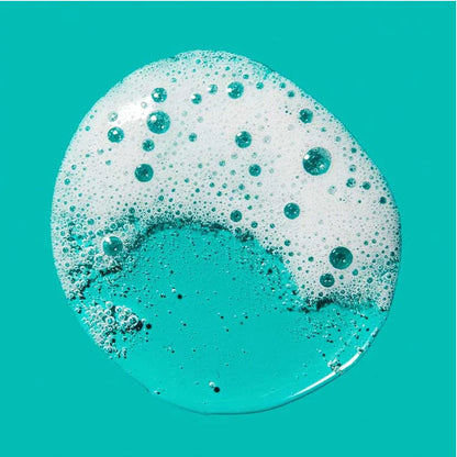 Droplet of lathered cleanser on turquoise green background
