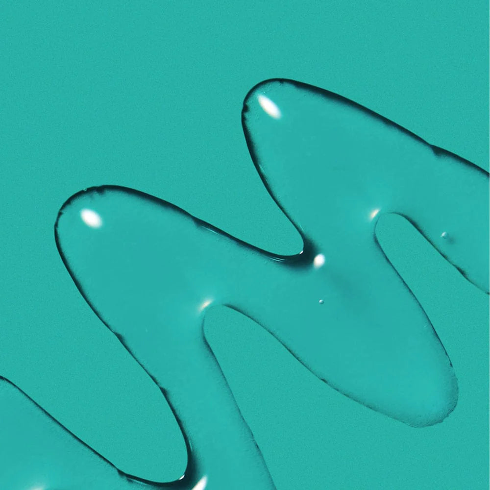 Clear gel rippled onto green background. Demonstrating a transparent gel.