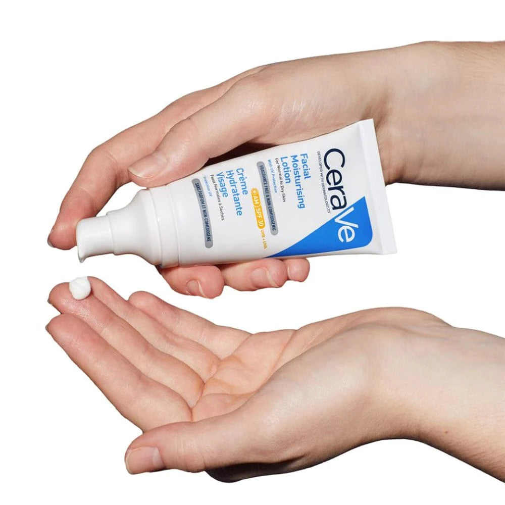 Photograph of CeraVe AM moisturizer with broad spectrum UVA/UVB protection, continuous hydration for upto 24 hours, lightweight, non-comedogenic formula, being dispensed from a pump top on a tub of lotion onto fingertips.