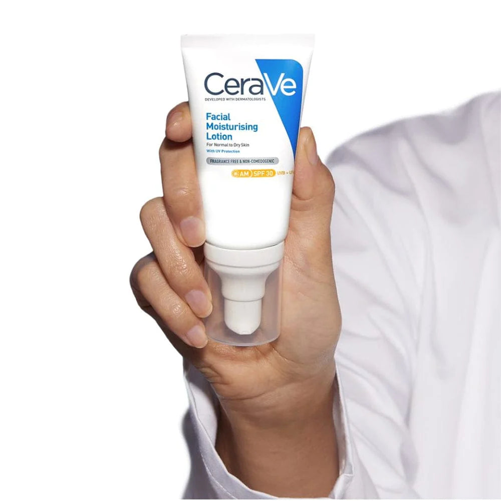 Photo of CeraVe AM moisturizer (lightweight, non-comedogenic formula) being held up with a white sleeved doctors lab coat in the background.