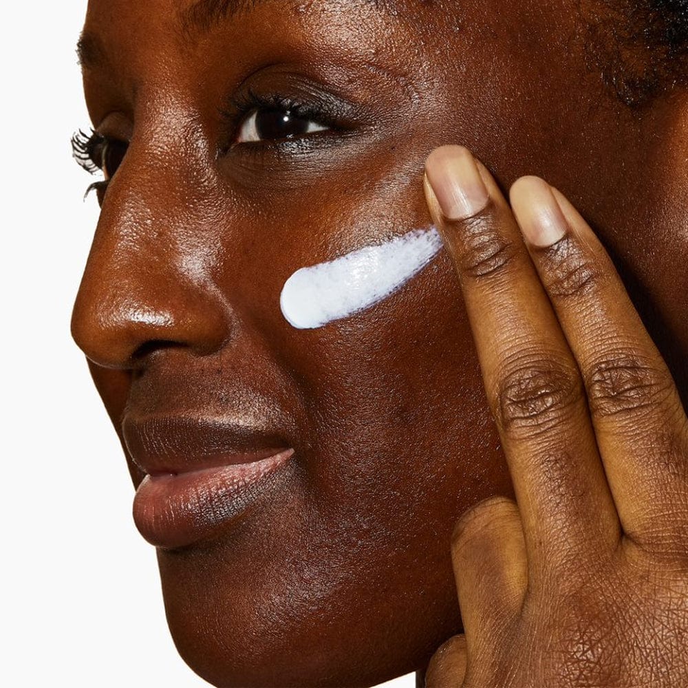 Image of application of moisturizing lotion or cream being applied to the cheek.