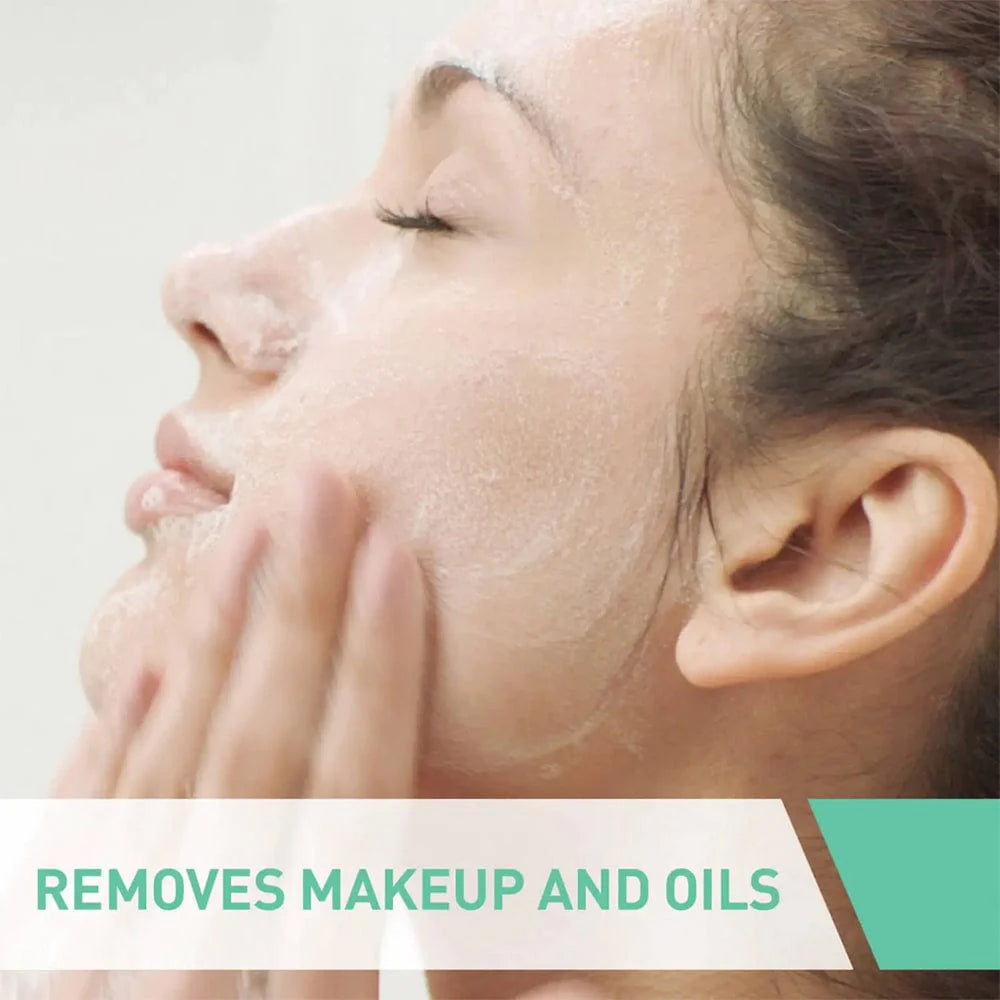 Image of a person massaging foaming cleanser with the statement removes makeup and oils.