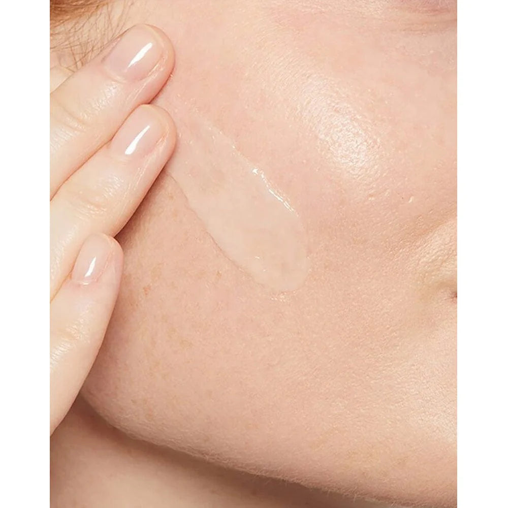 Image of CeraVe Hydrating Hyaluronic Acid Serum being applied to the cheek. Translucent formula.
