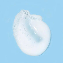 Image of a smear of foaming cream cleanser on a baby blue background