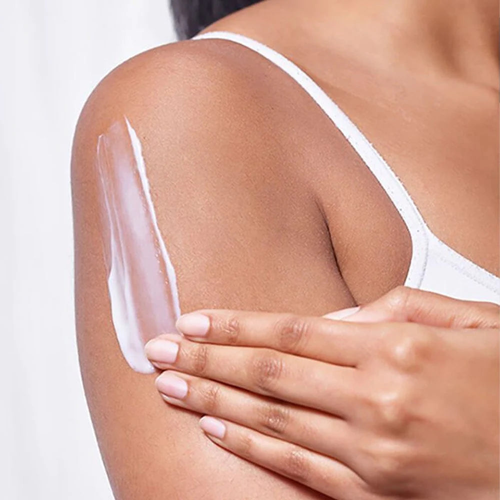 Image showing  white lotion being rubbed into upper arm.