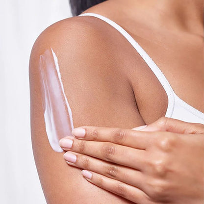 Image showing  white lotion being rubbed into upper arm.