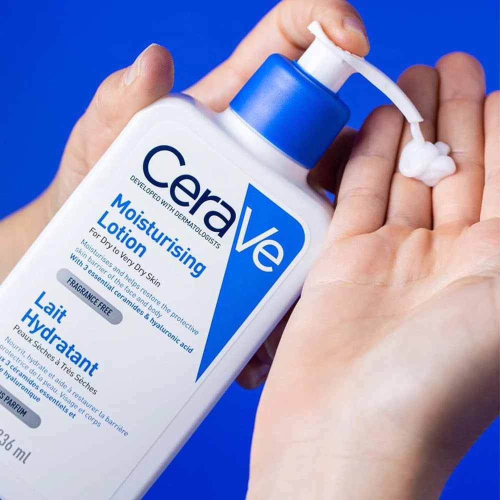 Image of white mosituriser being pumped onto fingertips from a blue and white CeraVe Developed with Dermatologists moisturising lotion for dry to very dry skin.