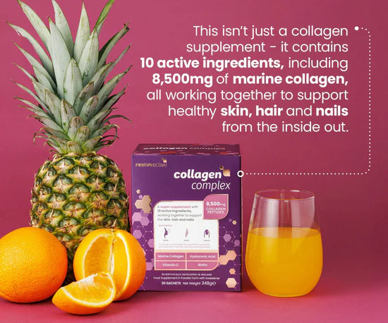 Collagen supplement box with pineapple, oranges, and juice on a pink background