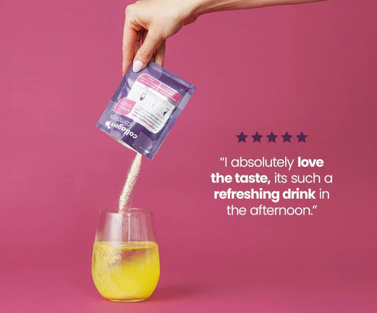 Hand pouring a drink mix into a glass with a pink background and text about the taste.